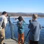 Color image of National Eagle Center visitors watch eagles from the center's observation deck, 2013.