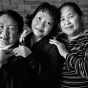 Black and white photograph of three generations of Hmong women (Mao Thao Yang, Mai Vang Thao, and Bo Thao), 1999.