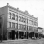 Black and white photograph of the façade of the Opera House Block on South Main Street as it looked in 1910.  