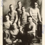 Black and white photograph of seven charter members of a secret society known as "The Greys," 1910. The group became the Nu Upsilon Gamma fraternity in 1920, disbanded in the 1990s and reactivated in 2001.