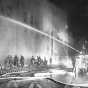 Black and white photograph of firefighters fighting the blaze at St. Paul's Temple of Aaron in 1952.