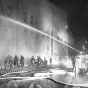 Black and white photograph of firefighters fighting the blaze at St. Paul's Temple of Aaron in 1952.