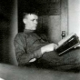 Black and white photograph of Charles Augustus Lindbergh and his photo album, Madison, Wisconsin, March, 1922.