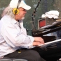 Longtime house pianist and music director Richard Dworsky plays during a live broadcast of A Prairie Home Companion at Macalester College in St. Paul, July 2015. Photograph by Wikimedia Commons user Jonathunder.