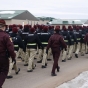 Color image of cadre and candidates of the Minnesota State Patrol’s Trooper Academy march between classes at Camp Ripley, February 2016.