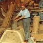 Color image of Robert Asp working on board the Hjemkomst. Photograph by Rose Asp, ca. 1980. From the Rose Asp Collection, Historical and Cultural Society of Clay County.