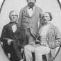 Black and white photograph of Rolette (standing) with business associates Henry Hastings Sibley (right), and possibly Franklin Steele (left), c.1857.