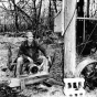 Black and white photograph of W. A. Benitt with electric pump at the windmill, 1938.