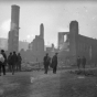 Black and white photograph of people and ruins after the fire, 1918.