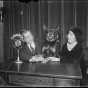 Thomas D. Schall with a German shepherd, possibly Lux, and a woman seated in front of a Columbia microphone