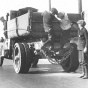 School Police gives warning to boys trying to hitch a ride on a truck.