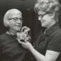 Black and white photograph of St. Catherine’s alumna Betty Hubbard (right) pinning a corsage on Alice Gustava Smith (Sister Maris Stella, left) at the College of St. Catherine in 1971. Photographed by P.J. Strasser. 