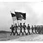 Soldiers marching with Twin Cities Ordnance Plant flag