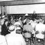 Black and white photograph of former president Harry Truman speaks to guests in Nelson Hall, the post’s headquarters, in July 1953