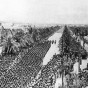 Black and white photograph of U.S. Soldiers of the Thirty-fourth Division marching through Tunis, 1943.