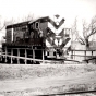 Black and white photograph of en turning a diesel locomotive on the Chicago, St. Paul, Minneapolis & Omaha turntable, ca. 1950s or 1960s.