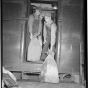 Railway Mail Service clerks load mail bags onto a Great Northern Railway Post Office car at the St. Paul Union Depot.