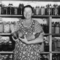 Woman with canned vegetables, part of Farm Security Administration program. 