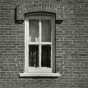 Black and white photograph of a window in the Arnold Nietfield house in Meire Grove.