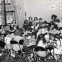 Black and white publicity photograph (taken c.1930) showing arts and crafts activates for kids enrolled at "Stay at Home Camp," a summer camp developed by the Jewish Center Activities Association, for the growing number of families joining the J. E. C.