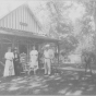 Photograph of four people in front of Villa Marie in Waconia. From left to right: Mrs. Emile Amblard; her mother, Mrs. Wood; Lillian Osterfelt; Mr. Emile Amblard. 