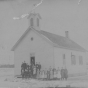 Photograph of Mayer public school (District #73) c.1895. Teacher Thomas Burns stands with his students outside the one-room schoolhouse. Photograph Collection, Carver County Historical Society, Waconia.