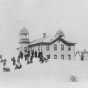 photograph of Dawson school with children playing in the snow.