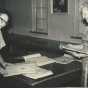 Black and white photograph of Eunice Morberg and Mae Rideout looking at Crookston BPW scrapbooks, 1959.