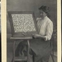 photograph of a young woman displaying bobbin lace