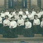 Black and white photograph of St. Catherine’s College, class of 1908, on the steps of Derham Hall.