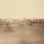 Black and white photograph of downtown Hanover seen from the Hennepin County side of the Crow River, ca. late 1800s.