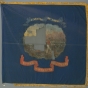 Blue silk battle flag with the state seal of Minnesota painted on the center