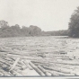 Black and white photograph of logs in the Red Lake River at Crookston, ca. 1890–1910.