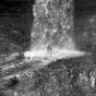 Two women in bathing suits under Minnehaha Falls