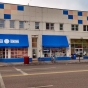 Color image of the exterior of Mercado Central, a cooperatively owned market featuring forty-five Latino-owned businesses at 1515 East Lake Street in Minneapolis, February 20, 2016. Photographed by Lizzie Ehrenhalt.