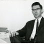 Black-and-white photograph of Professor Roy W. Meyer at his Mankato State College desk in the early 1960s.