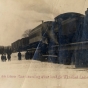 Black and white photograph of the first train on the Luce Line railroad crossing over the bridge at Winsted Lake, ca. 1900.