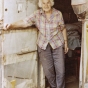 Color image of Dorothy Molter at the door of her summer tent on Knife Lake, ca. 1985.