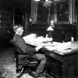 Governor John Lind seated in his office in the State Capitol