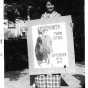 Photograph of Wanda Gág with a poster she submitted in a contest, 1914.