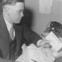 Black and white photograph of Elmer Benson at his desk, c.1934. Photographed by the St. Paul Daily News.