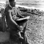 Black and white photograph of Elmer Benson by a lake, 1937. 