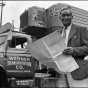 Black and white photograph of Frederick McKinley Jones standing next to a truck outfitted with a mobile refrigeration unit, c.1950.
