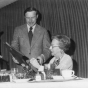 Black and white photograph of Helen E. (Davis) McMillan of Austin receiving a plaque from Martin Sabo at her recognition banquet in Austin, March 18, 1975.