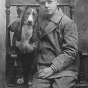 Black and white photograph of Charles Lindbergh with his dog "Dingo," c.1912. 