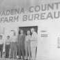 Photograph of Val Bjornson in front of Wadena County Farm Bureau Building with Joe Langer, Fred Miller and others, c. 1954.