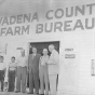 Photograph of Val Bjornson in front of Wadena County Farm Bureau Building with Joe Langer, Fred Miller and others, c. 1954.