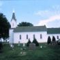 A side view of the Swedish Evangelical Lutheran Church, (Our Savior’s Lutheran Church), Ham Lake, including part of the cemetery. This image was originally a slide. Photographer and date unknown.