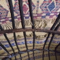 Photograph of the interior roof of an aqal, a traditional Somali home held together by ropes and thick branches and covered with kabad (hand-woven mats)