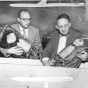 Rabbis Herman M. Cohen and Bernard S. Raskas prepare burned sacred articles for burial at the Temple of Aaron fire site, Ashland and Grotto, St. Paul.